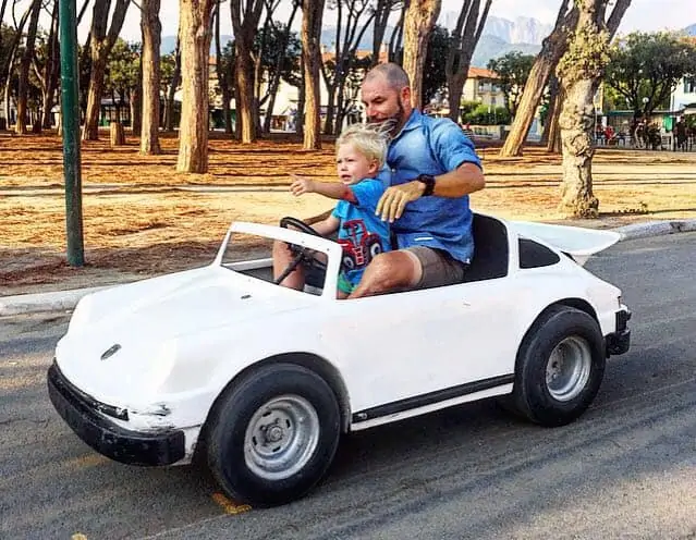 man and son drive mini race car in piazza in Forte dei Marmi