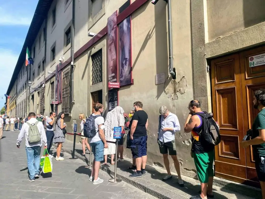 people waiting in line to enter the accademia in florence