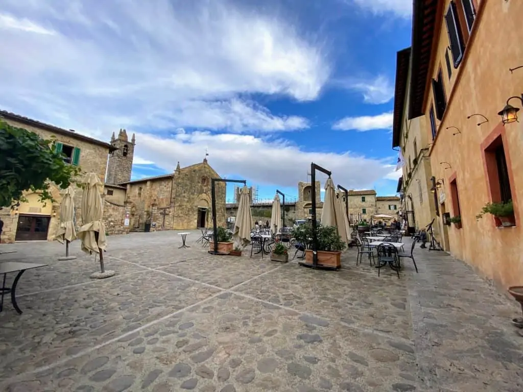 An empty view of Piazza Roma in Monteriggioni, Italy on a sunny day.