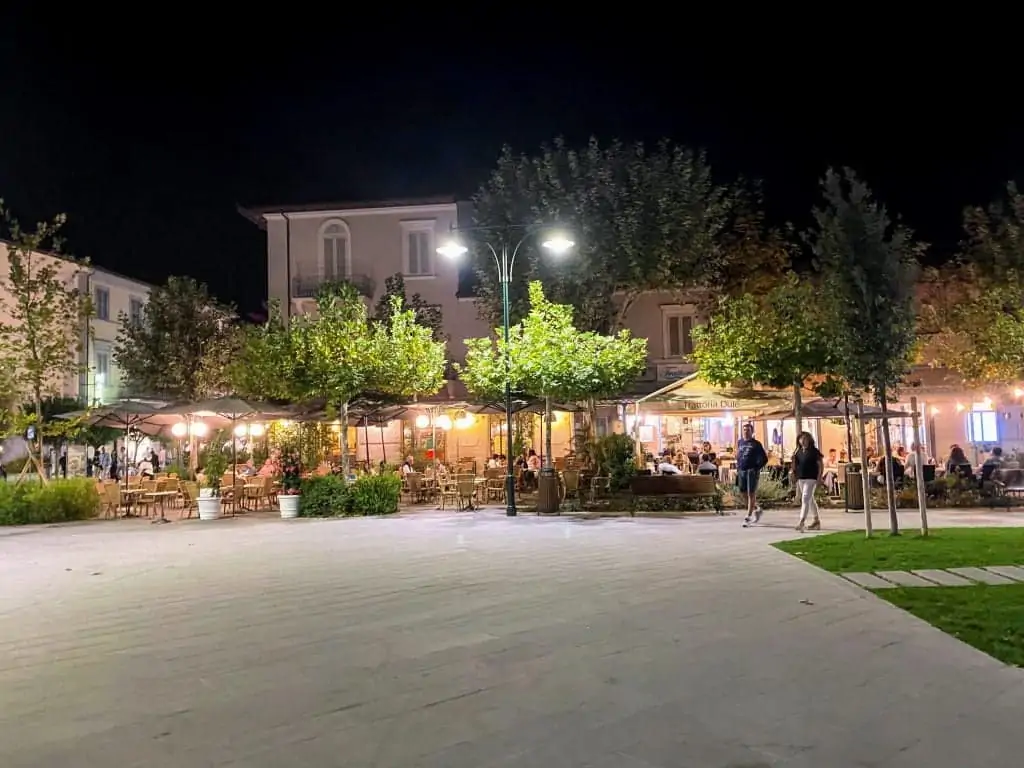 nighttime at a piazza in forte dei marmi with restaurants in the background