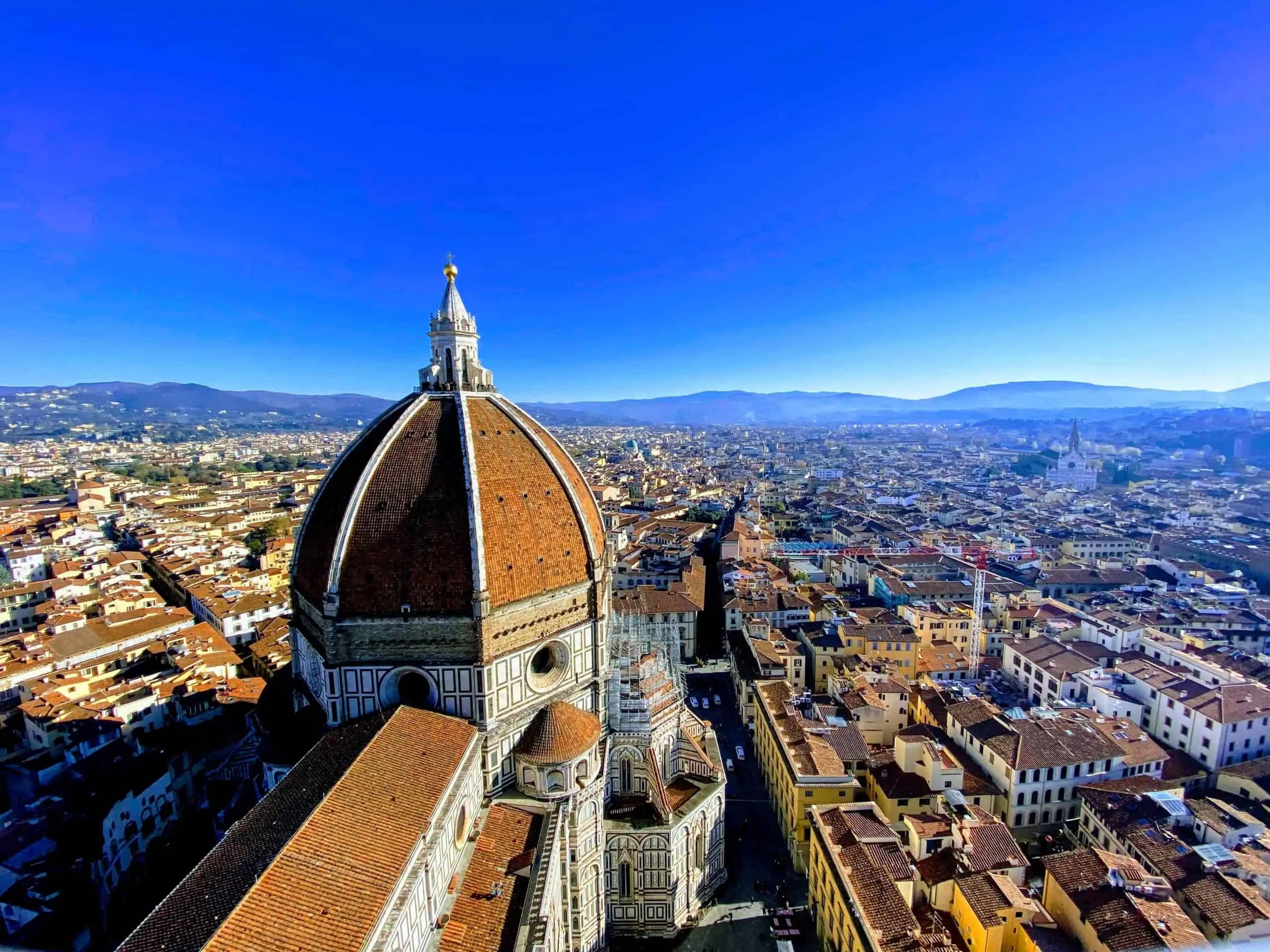 View of the Duomo, city, and surrounding Tuscan countryside from the top of Giotto's bell tower in Florence, Italy.