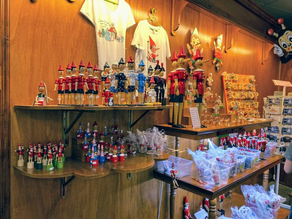 A section of the Pinocchio Park gift shop, with figurines, t-shirts, pencils, and wall decorations.