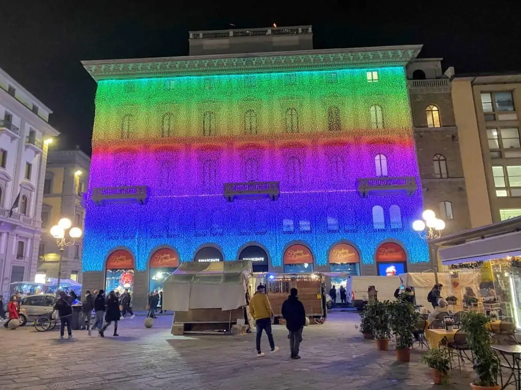 Rainbow holiday lights cover the entire Rinascente department store in Piazza della Repubblica in Florence, Italy.  