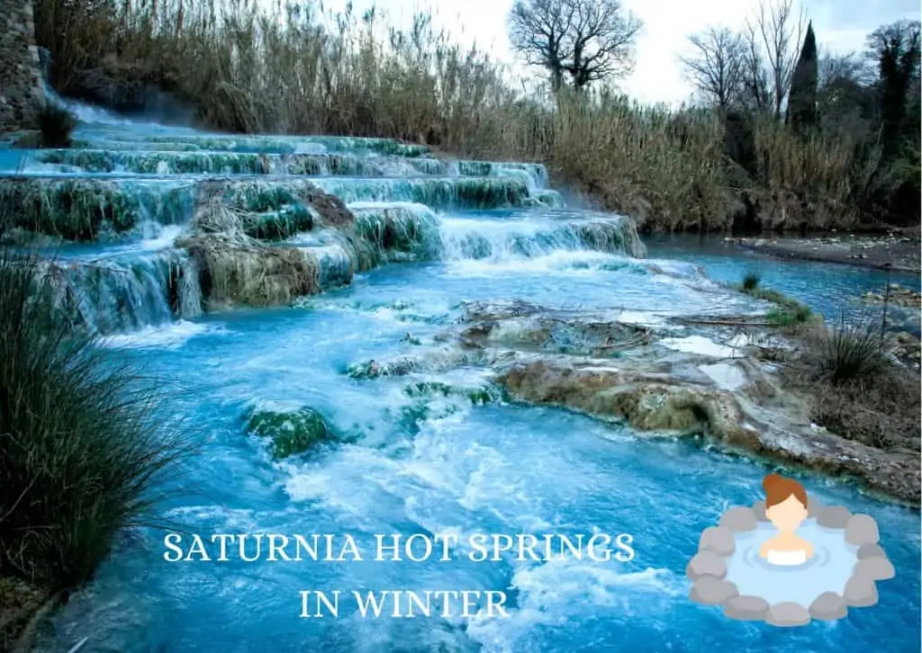 Saturnia hot springs in winter.  Cascading hot springs surrounded by brown tall grasses and a few treese without leaves.  There is a graphic of a woman in the spring surrounded by stones.