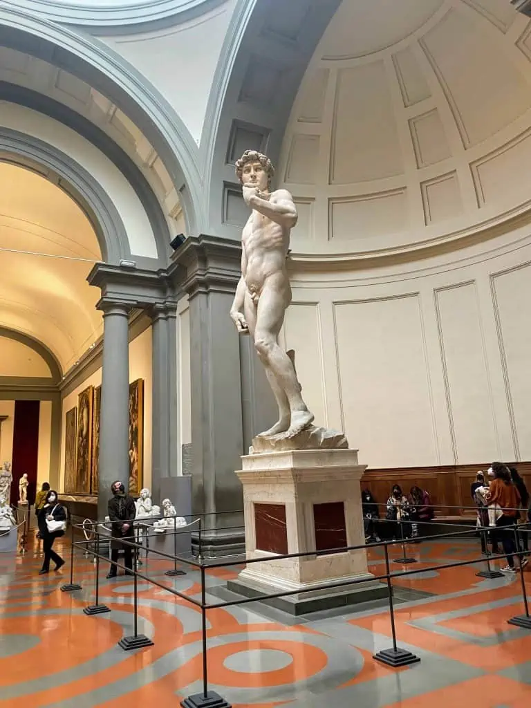 Michelangelo's David statue towering inside the Accademia Gallery in Florence, Italy.