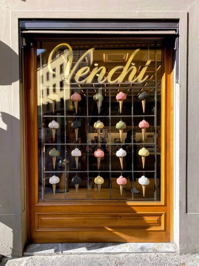 Window display at Venchi in Florence, Italy.  You can see the wall of chocolate through the window.