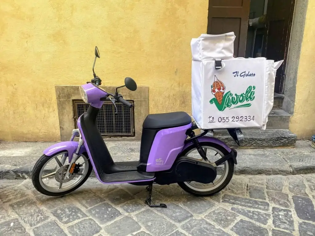 Vivoli gelato delivery scooter parked on a street in Florence, Italy.
