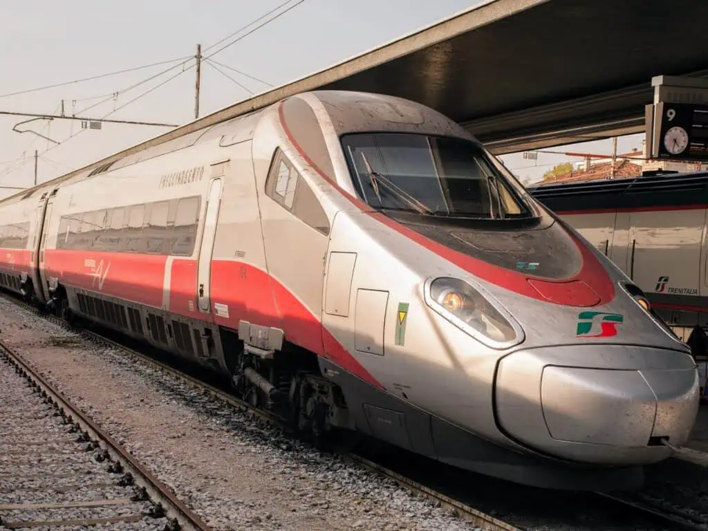 Frecciargento high-speed train of Trenitalia at a station on a grey day.
