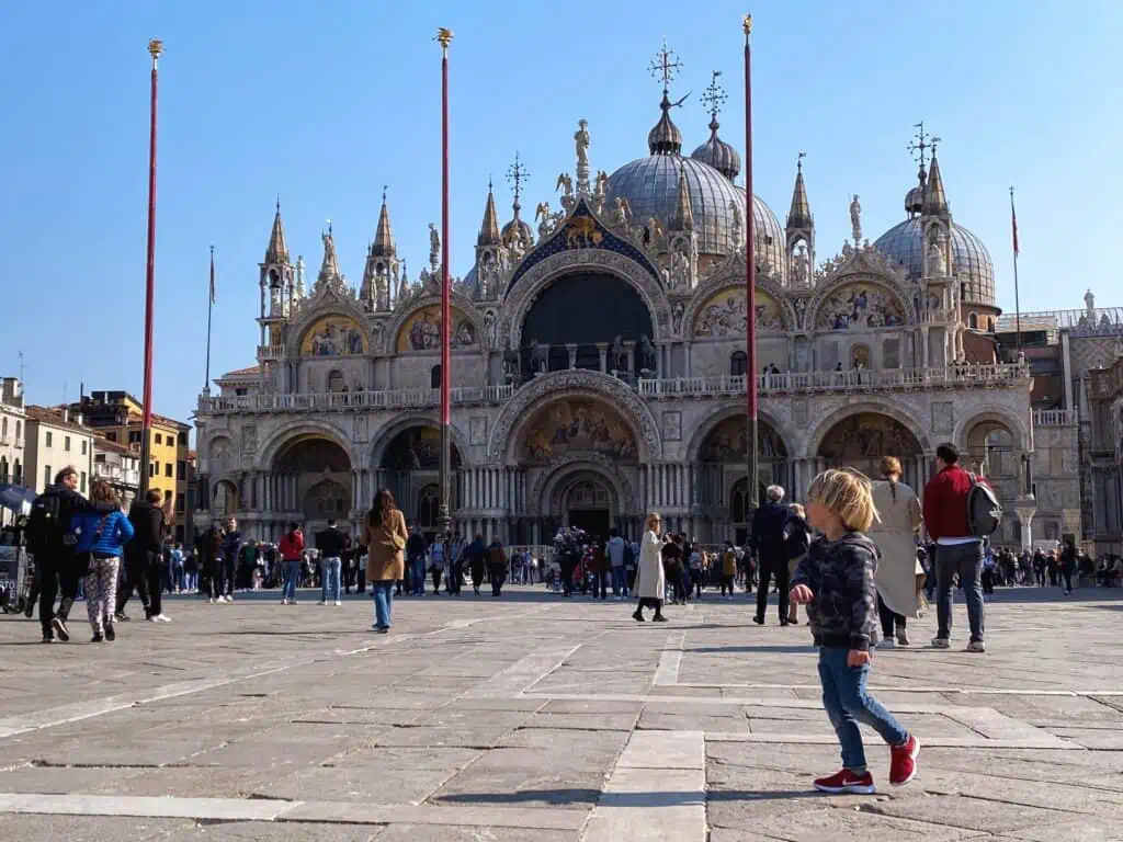 Boy standing in Piazza San Marco in Venice, Italy.