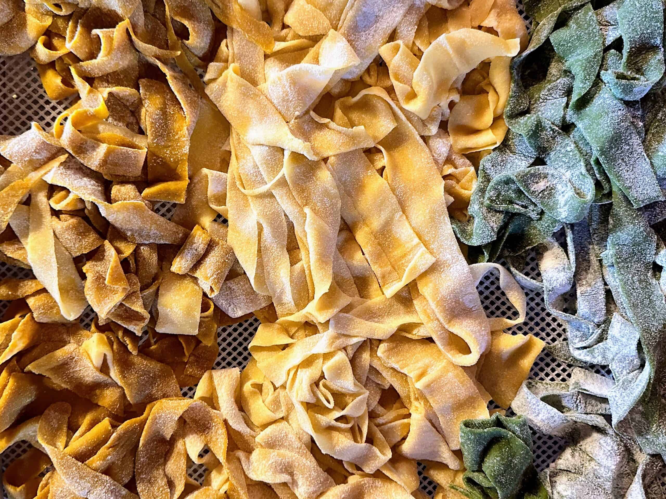 Close up of fresh pasta drying on a rack.