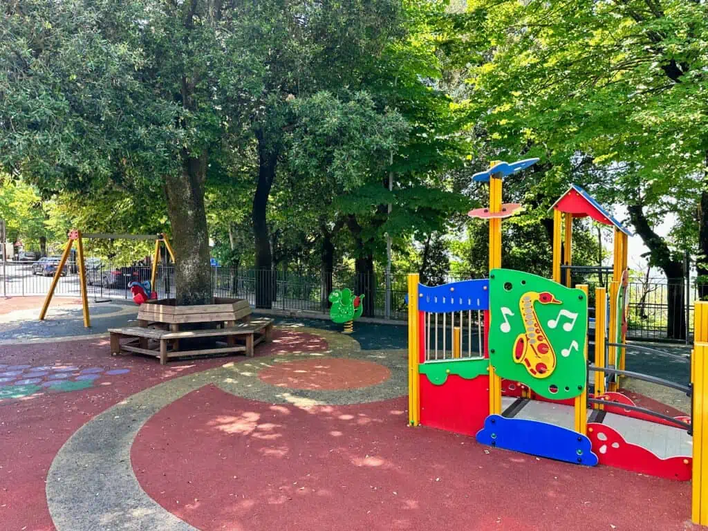 Colorful playground and trees in Castellina in Chianti, Italy.