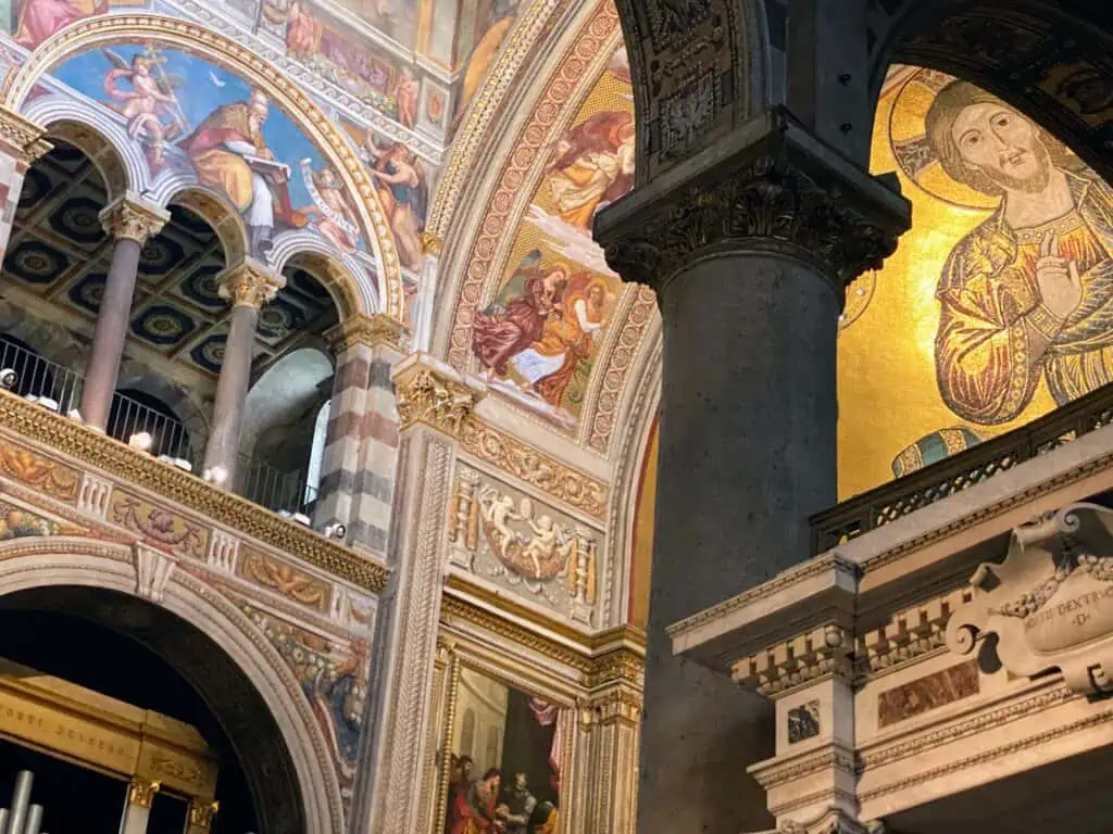 Colorful frescoes and mosaics inside the Duomo in Pisa, Italy.
