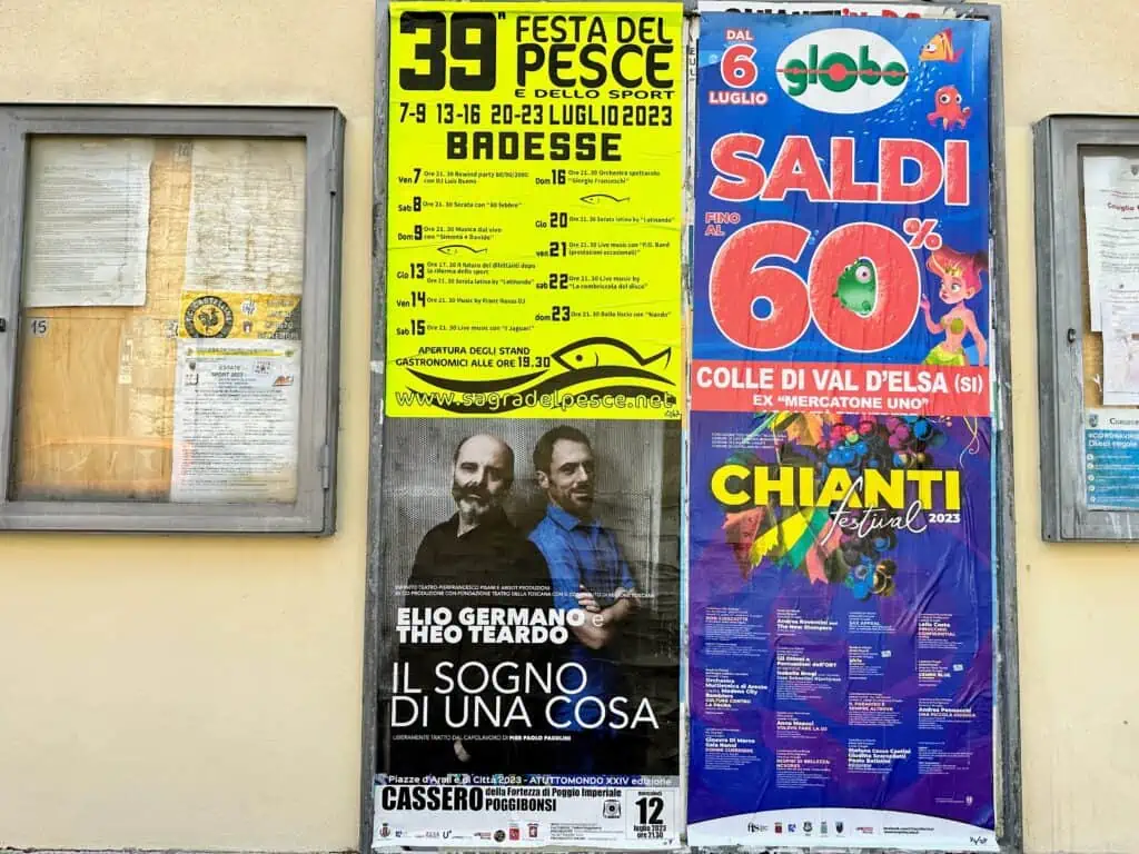 Posters for sagre and festivals on a wall in Tuscany, Italy.
