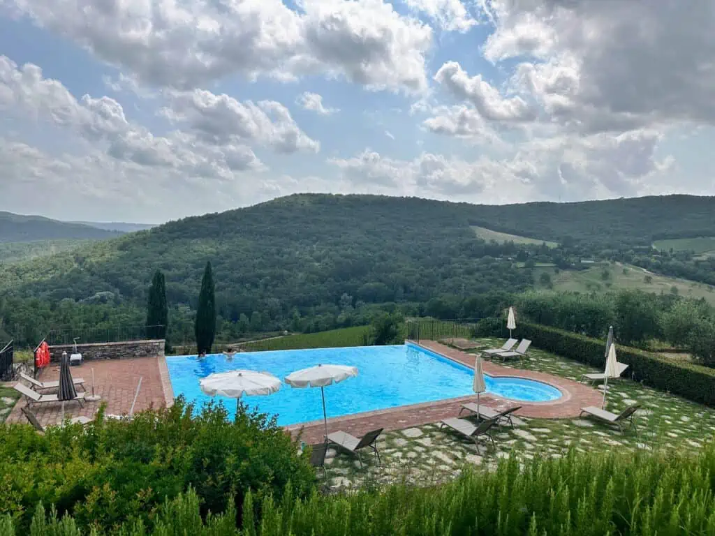 Pool and countryside views at Castello di Meleto in Chianti, Tuscany.
