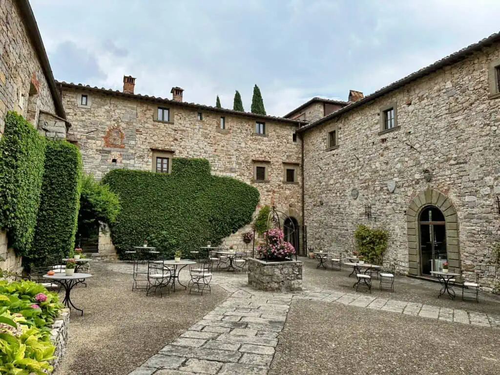 Outdoor seating area of Il Pievano restaurant at Castello di Spaltenna. It's day time, so the tables aren't set.