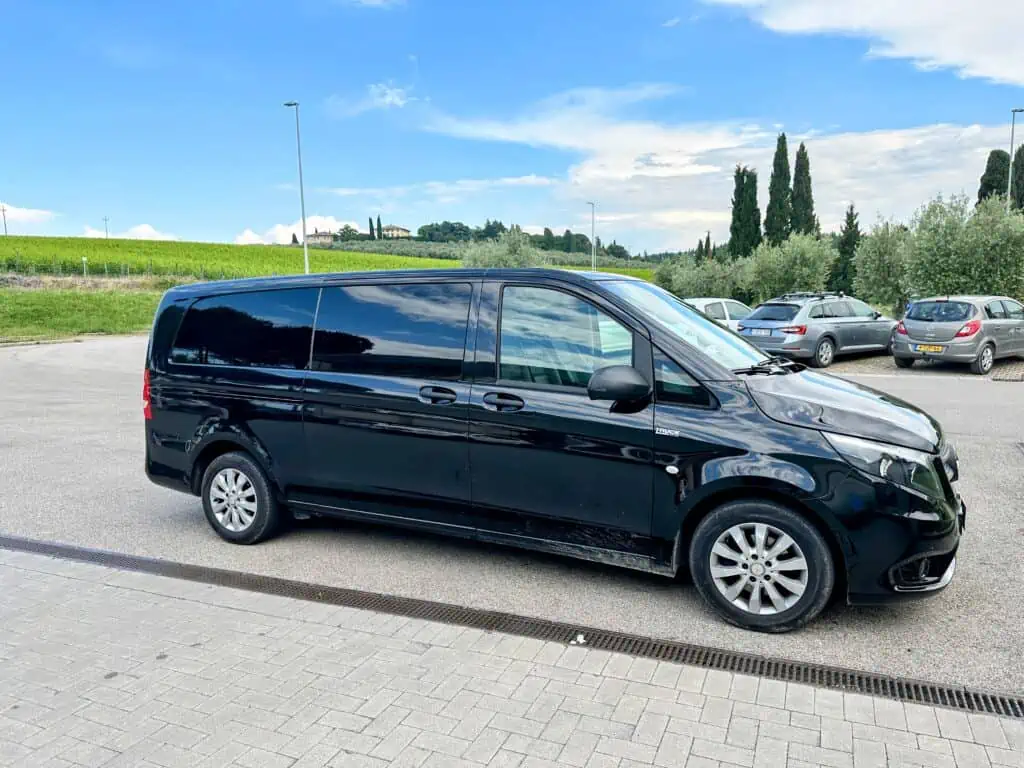Black van in a parking lot in Chianti, Tuscany.