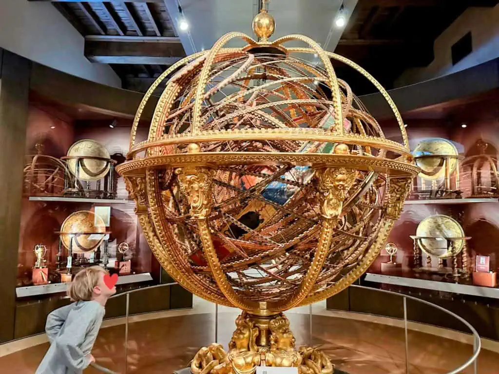 Boy looking at globe in Galileo Museum in Florence, Italy.