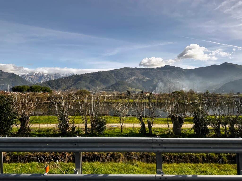 View of countryside and Apuan Alps from the road in Versilia, Italy.