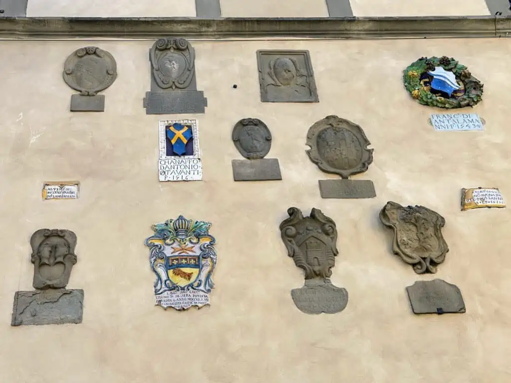 Coats of arms on a wall of a building in Radda in Chianti, Italy.