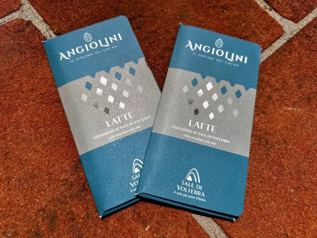Two chocolate bars from the Saline di Volterra sitting on a terracotta surface.