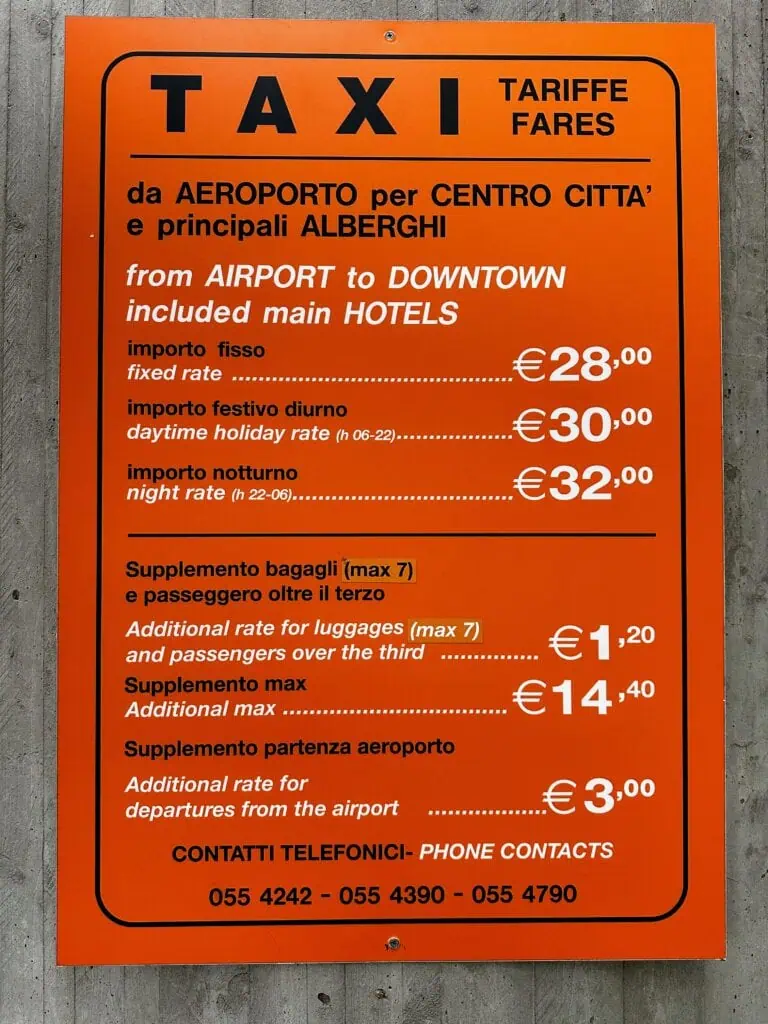 Orange sign with Florence, Italy taxi rates.