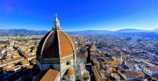 View of the Duomo, city, and surrounding Tuscan countryside from the top of Giotto's bell tower in Florence, Italy.
