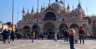Boy standing in Piazza San Marco in Venice, Italy.